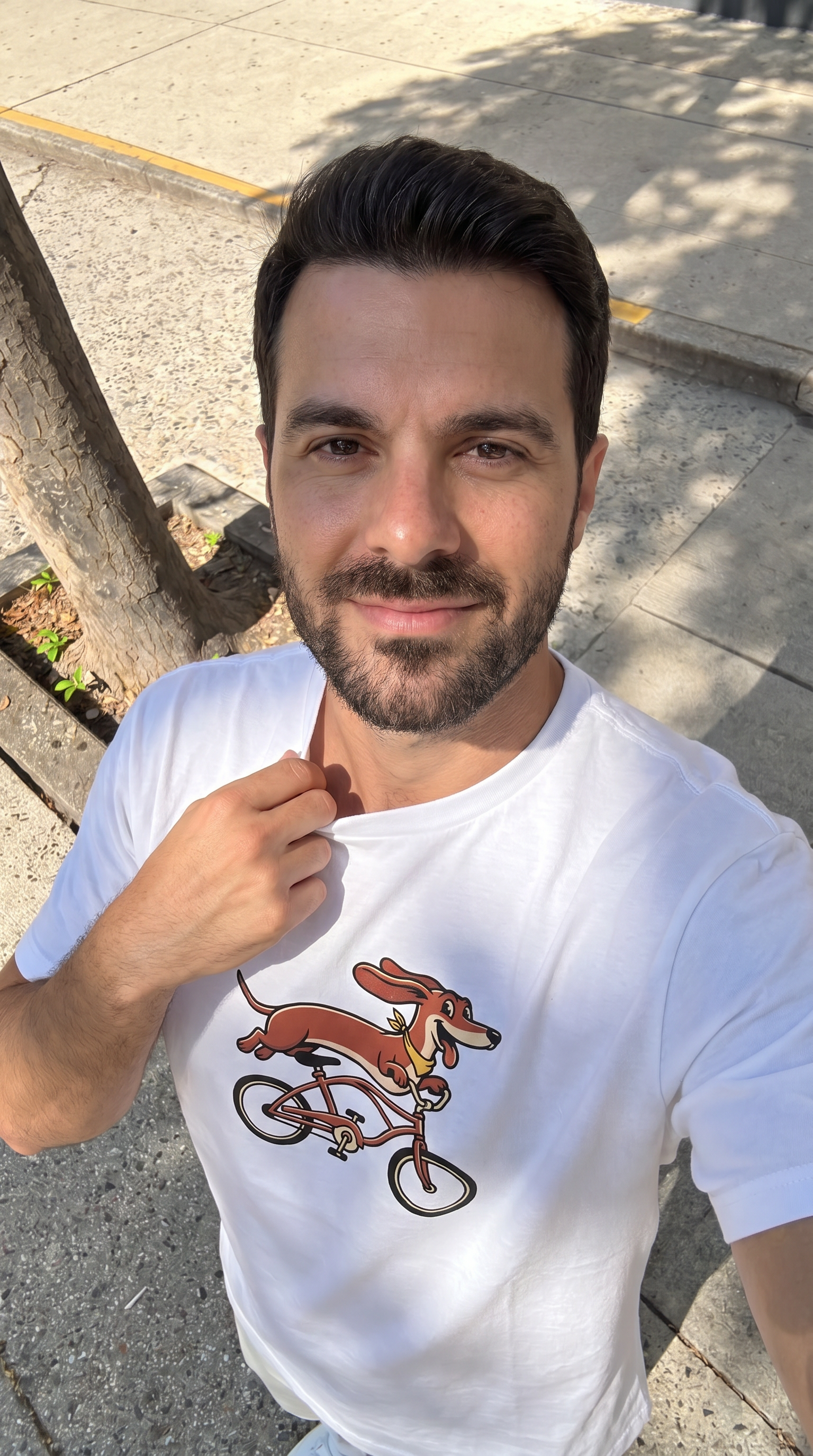 Person wearing the Dachshund on a Bike unisex t-shirt outdoors