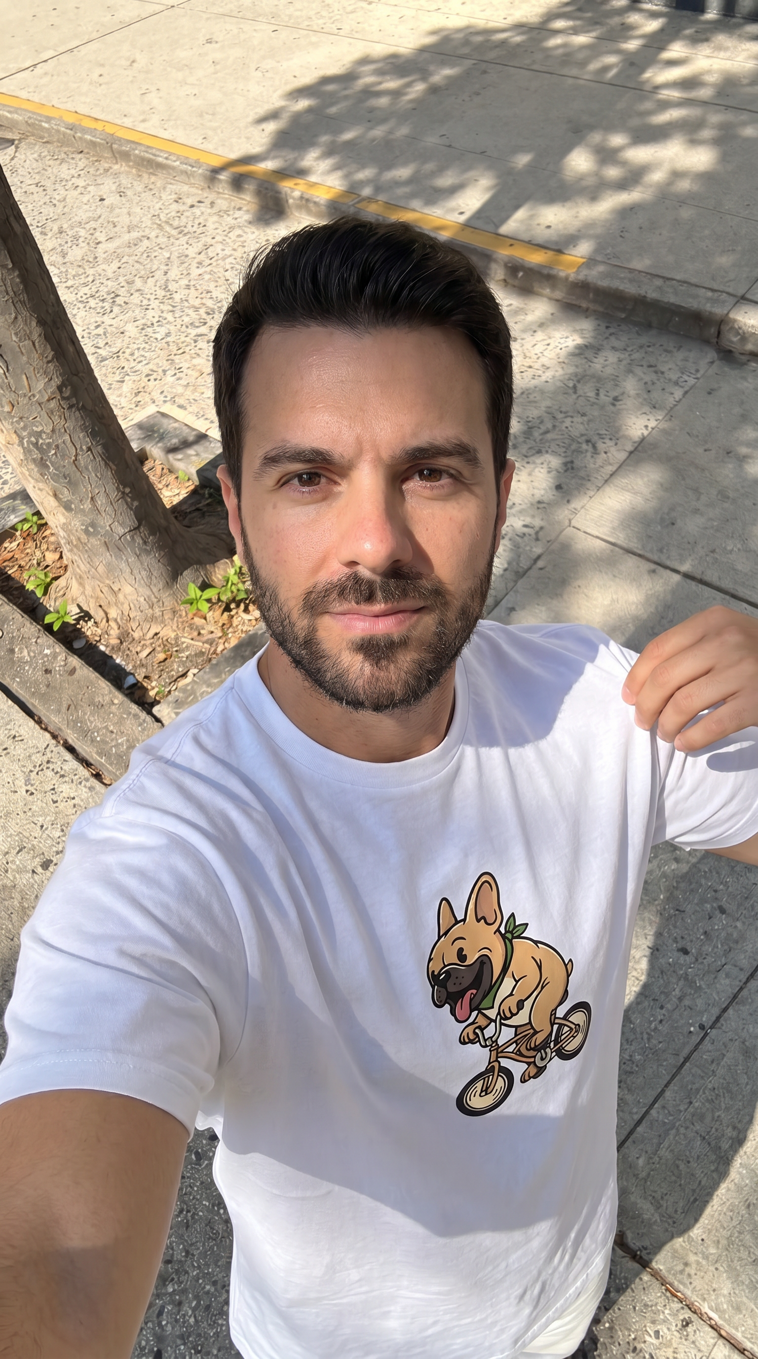 Person wearing the French Bulldog on a Bike unisex t-shirt outdoors